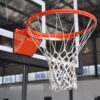 39661-4 | National Sports Products Close-up of an orange basketball hoop with white net attached to a backboard in an indoor gym.