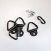 Black metal triangular D-ring hardware with a hinged base plate and mounting holes, plus small carabiner and screws (hardware kit)