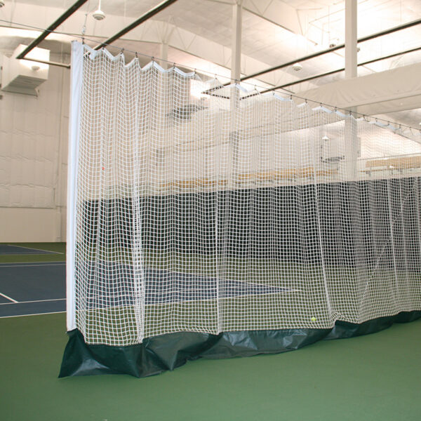 23955Z | National Sports Products Indoor gym with a white mesh netting enclosure forming a practice cage on green flooring and padded base.