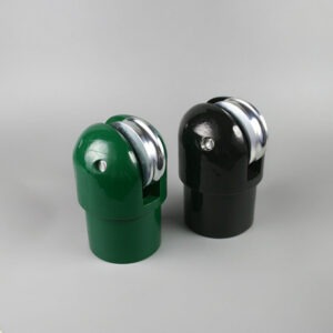 Two plastic pencil sharpeners, green and black, with metal blades facing forward on a light background.